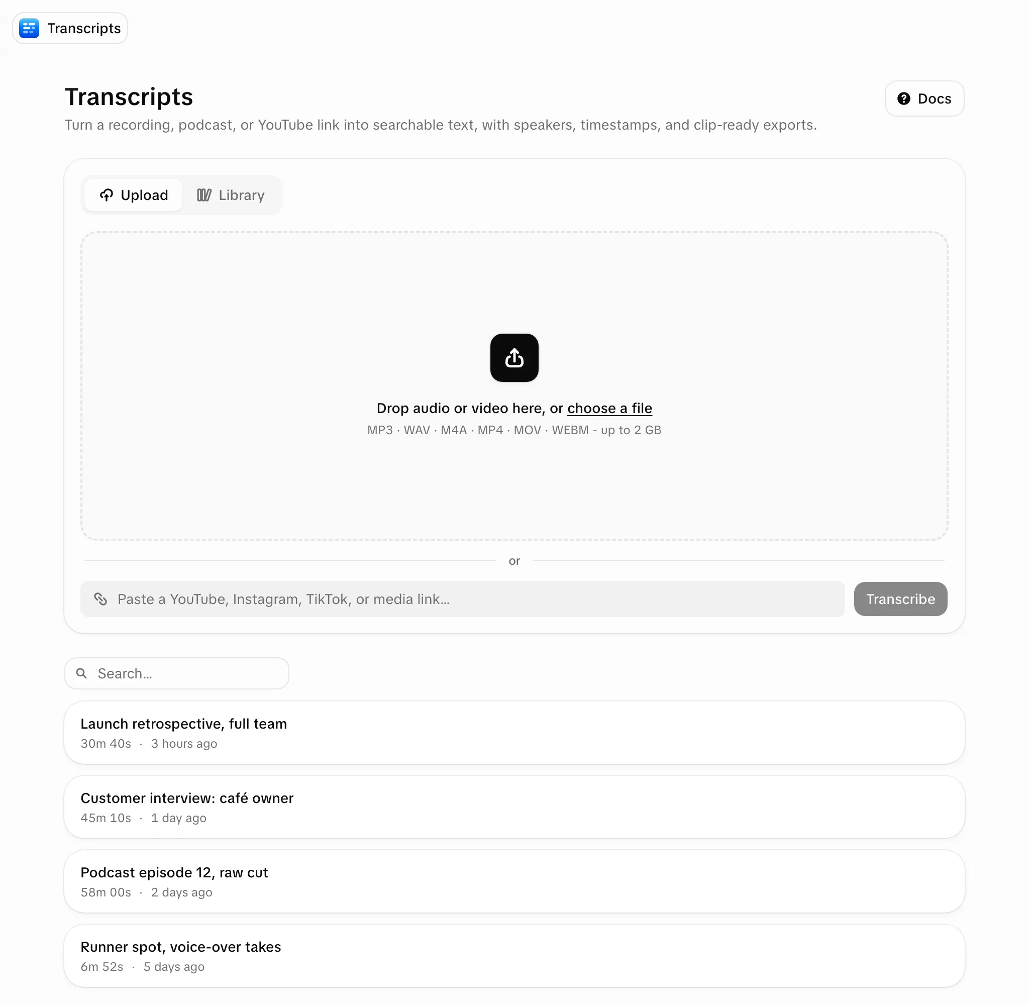 The Transcripts page: an uploader with Upload and Library tabs, a drop zone for audio or video, and a field to paste a YouTube, Instagram, TikTok or media link beside a Transcribe button; below, a search field and the workspace's transcripts with their length and age